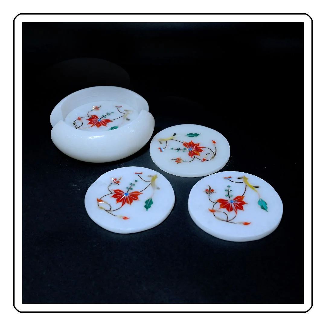 Polished marble coaster with embedded red stone pattern – handmade and durable
