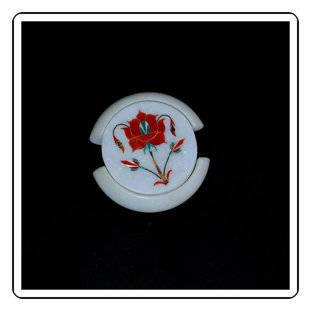 Side view of handcrafted marble coaster with red flower art.